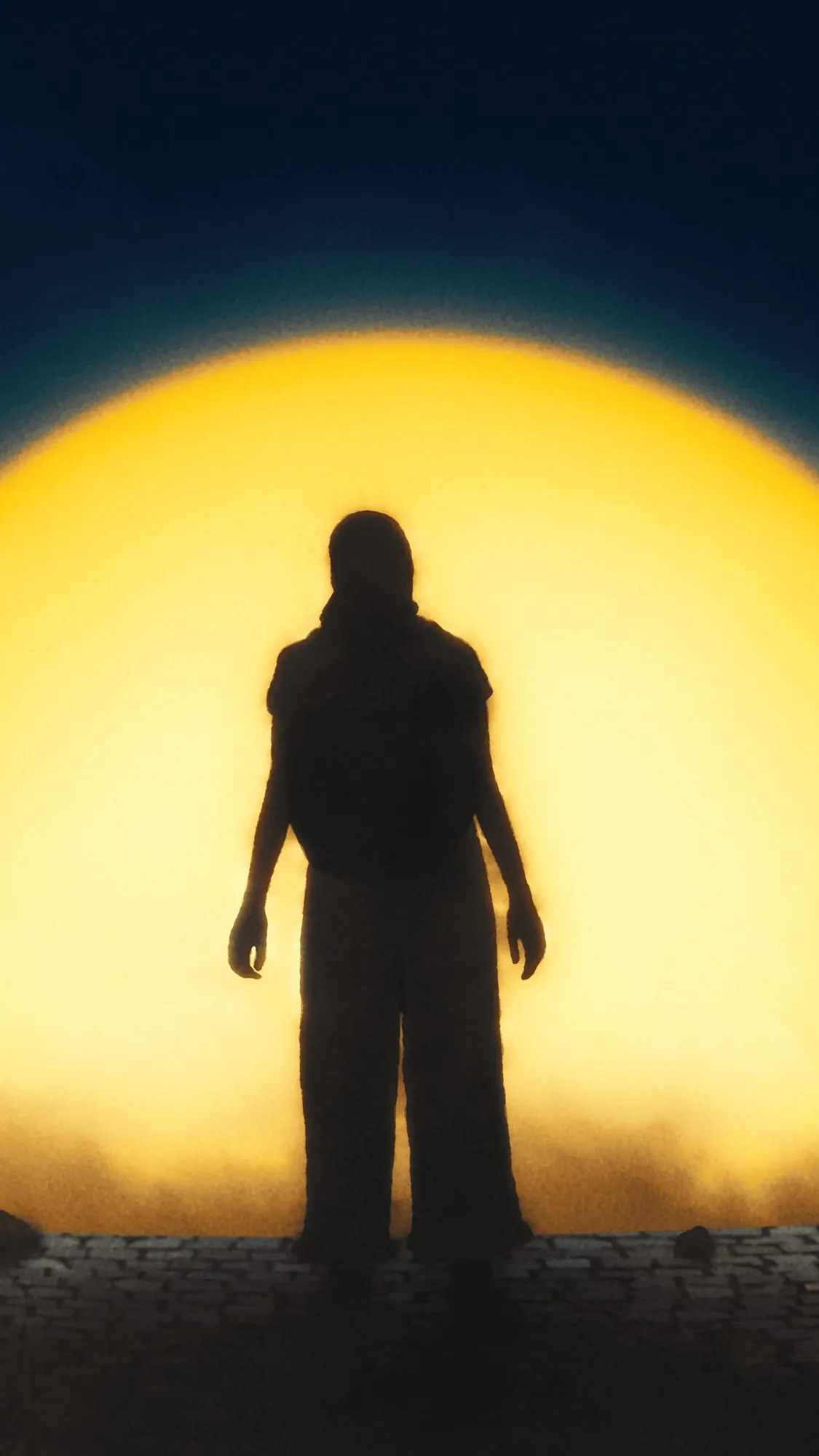 A still from the ad, a student's silhouette standing in front of a huge yellow sun.